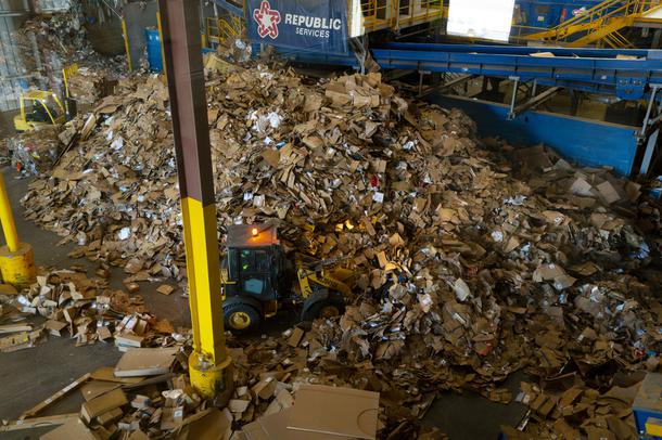 A bulldozer pushes cardboard at the Republic Services of Southern Nevada Recycling Center in North Las Vegas, Friday, March 26, 2021.