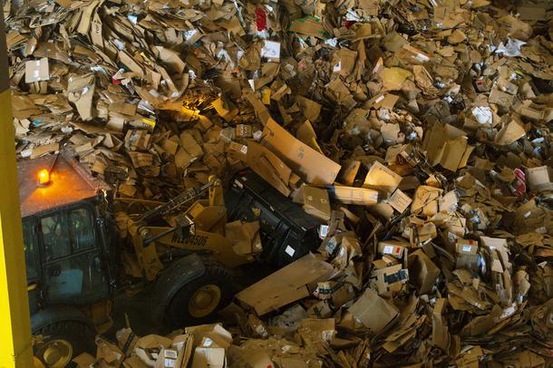 A bulldozer pushes cardboard at the Republic Services of Southern Nevada Recycling Center in North Las Vegas, Friday, March 26, 2021.