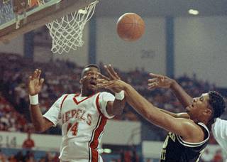 University of Nevada Las Vegas's George Ackles, left, and Cal State Long Beach's Frankie Edwards, right, jump up to take down a rebound in the first half of first round Big West tournament at Long Beach Arena, March 8, 1991. (AP Photo/Sam Jones)