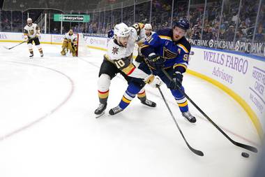 St. Louis Blues’ Vladimir Tarasenko, right, handles the puck as Vegas Golden Knights’ Nicolas Roy (10) defends during the second period of an NHL hockey game Wednesday, April 7, 2021, in St. Louis. 