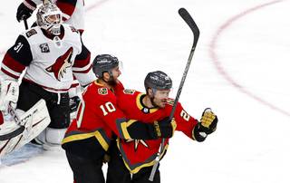 Vegas Golden Knights left wing William Carrier (28) celebrates with center Nicolas Roy (10) after scoring past Arizona Coyotes goaltender Adin Hill (31) in the first period of a game at T-Mobile Arena Friday, April 9, 2021.