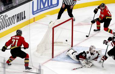 Vegas Golden Knights right wing Reilly Smith (19) scores past Arizona Coyotes goaltender Adin Hill (31) in the first period of a game at T-Mobile Arena Friday, April 9, 2021. Vegas Golden Knights center William Karlsson (71) is at left. 