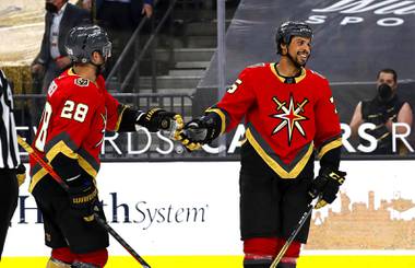 Vegas Golden Knights left wing William Carrier (28) and right wing Ryan Reaves (75) celebrate after the Golden Knights beat the Arizona Coyotes, 7-4, at T-Mobile Arena Friday, April 9, 2021. 