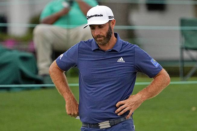 Dustin Johnson looks down after putting on the 18th hole during the second round of the Masters golf tournament on Friday, April 9, 2021, in Augusta, Ga. 