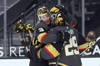 Vegas Golden Knights defenseman Brayden McNabb (3) and goaltender Marc-Andre Fleury (29) embrace after defeating the Arizona Coyotes in an NHL hockey game Sunday, April 11, 2021, in Las Vegas.