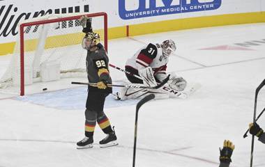 Vegas Golden Knights left wing Tomas Nosek (92) reacts after scoring against Arizona Coyotes goaltender Adin Hill (31) during the third period of an NHL hockey game Sunday, April 11, 2021, in Las Vegas. (AP Photo/David Becker)