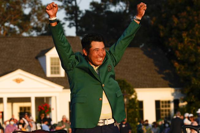 Hideki Matsuyama, of Japan, celebrates during champion's green jacket ceremony after winning the Masters golf tournament on Sunday, April 11, 2021, in Augusta, Ga. 

