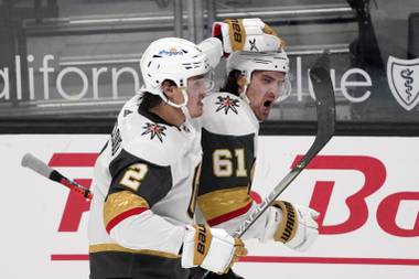 Vegas Golden Knights right wing Mark Stone, right, celebrates his goal with defenseman Zach Whitecloud during the second period of an NHL hockey game against the Los Angeles Kings Monday, April 12, 2021, in Los Angeles. (AP Photo/Mark J. Terrill)