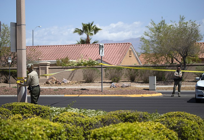 Metro Police officers put crime scene tape across lake Mead Boulevard after a fatal accident on Lake Mead Boulevard near Rampart Boulevard in Summerlin Wednesday, April 14, 2021.