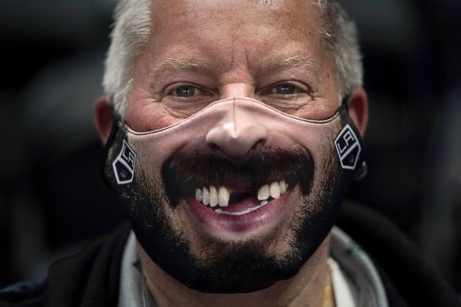 Wearing a mask depicting Los Angeles Kings' Drew Doughty, Doug Hiner attends an NHL hockey game between the Anaheim Ducks and the Vegas Golden Knights, Saturday, April 24, 2021, in Anaheim, Calif.