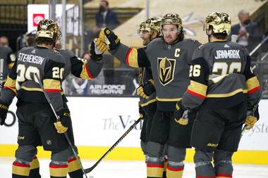 Vegas Golden Knights right wing Mark Stone, second from right, celebrates after scoring against the San Jose Sharks during the second period of an NHL hockey game Monday, April 19, 2021, in Las Vegas. 