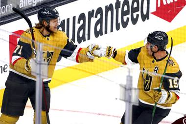 Vegas Golden Knights center William Karlsson (71) celebrates with right wing Reilly Smith (19) after scoring in the first period of a game against the Colorado Avalanche at T-Mobile Arena Wednesday, April 28, 2021.
