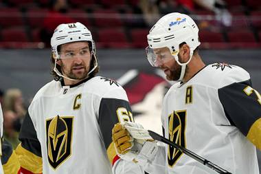 Vegas Golden Knights right wing Mark Stone (61) talks with Vegas Golden Knights defenseman Alex Pietrangelo (7) during the third period of an NHL hockey game against the Arizona Coyotes Saturday, May 1, 2021, in Glendale, Ariz. The Golden Knights defeated the Coyotes 3-2 in overtime. (
