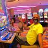 In this July 2, 2020, file photo, Gary Royster of Atlantic City holds up a wad of cash he used to gamble at the Hard Rock casino in Atlantic City on the day the casino reopened after being shut down for months amid the coronavirus outbreak. 