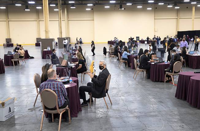Job seekers get offers from recruiters during an MGM Resorts hiring fair at the Mandalay Bay Convention Center Tuesday, May 4, 2021.