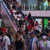 People ride an escalator along the Las Vegas Strip, Saturday, April 24, 2021, in Las Vegas. 