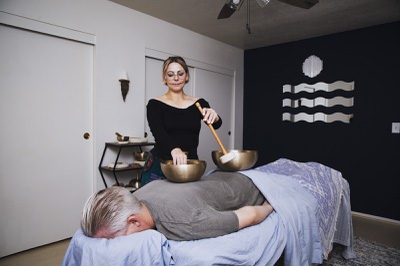 Vibrational Sound Therapist Carey-Sue Kaplan demonstrates a sound therapy session on a model Thursday, April 29, 2021.