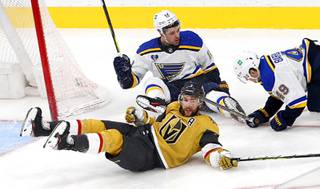 Vegas Golden Knights defenseman Alex Pietrangelo (7) falls with St. Louis Blues left wing Zach Sanford (12) and center Ivan Barbashev (49) in the third period of a game at T-Mobile Arena Saturday, May 8, 2021. Pietrangelo was penalized for tripping. 