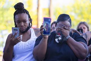 Mekala Hal, left, and Arielle Mathews, friends of Amari Nicholson's grandmother, attend a vigil for Amari in front of the Emerald Suites on Paradise Road Wednesday, May 12, 2021. Terrell Rhodes, 27, the boyfriend of Amari's mother, has been arrested on a murder count in connection with Amari's death.