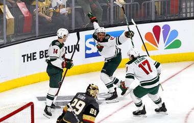 Minnesota Wild center Joel Eriksson Ek (14),  left wing Jordan Greenway (18) and left wing Marcus Foligno (17) celebrate after Eriksson Ek scored on Vegas Golden Knights goaltender Marc-Andre Fleury (29) during overtime in Game 1 of a playoff series at T-Mobile Arena Sunday, May 16, 2021.