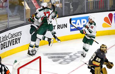 Vegas Golden Knights goaltender Marc-Andre Fleury (29) skates away as Minnesota Wild players celebrate their 1-0 overtime victory  in Game 1 of a playoff series against the Minnesota Wild at T-Mobile Arena Sunday, May 16, 2021. 