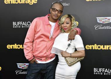 In this Monday, June 1, 2015 file photo, T.I., left, and Tiny arrive at the Los Angeles premiere of “Entourage” at the Westwood Regency Village Theatre. Rapper T.I. and his wife Tameka “Tiny” Harris are under investigation by police in Los Angeles after a sexual abuse allegation. Los Angeles Police officer Rosario Cervantes said Tuesday, May 18, 2021 that an active investigation is underway. 