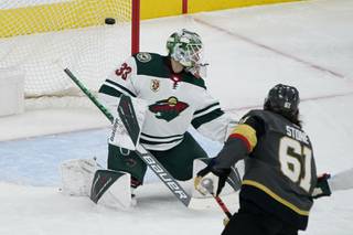 Vegas Golden Knights right wing Mark Stone (61) scores on Minnesota Wild goaltender Cam Talbot (33) during the first period of an NHL hockey game Monday, May 24, 2021, in Las Vegas. (AP Photo/John Locher)