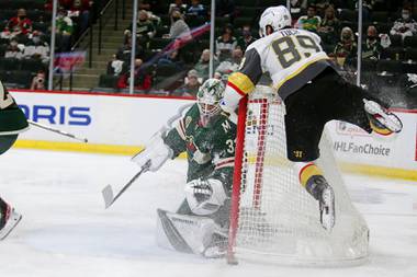 Minnesota Wild goaltender Cam Talbot (33) stops a shot by Vegas Golden Knights right wing Alex Tuch (89) during the second period in Game 6 of an NHL hockey Stanley Cup first-round playoff series Wednesday, May 26, 2021, in St. Paul, Minn.