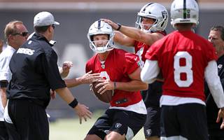 Las Vegas Raiders quarterback Nathan Peterman, center, is shown with quarterback Derek Carr (4) and quarterback Marcus Mariota (8) during an off-season practice at the Raiders practice facility in Henderson Wednesday, May 26, 2021.