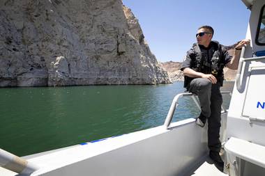 State Game Warden Thomas Hamblin looks out from his patrol boat at Lake Mead Thursday, May 27, 2021. Game wardens are classified as peace officers and can enforce all state laws, he said.