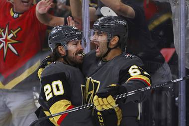 Vegas Golden Knights center Chandler Stephenson (20) cheers on left wing Max Pacioretty (67), who scored a goal against the Minnesota Wild during the second period of Game 7 of an NHL hockey Stanley Cup first-round playoff series Friday, May 28, 2021, in Las Vegas.