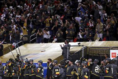 The Vegas Golden Knights bench celebrates the team’s final goal against the Minnesota Wild during the third period of Game 7 of an NHL hockey Stanley Cup first-round playoff series Friday, May 28, 2021, in Las Vegas.