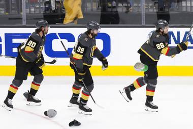Vegas Golden Knights center Chandler Stephenson (20), Vegas Golden Knights right wing Alex Tuch (89) and Vegas Golden Knights center Mattias Janmark (26) celebrate as Janmark earns a hat trick during the third period of Game 7 of an NHL hockey Stanley Cup first-round playoff series against the Minnesota Wild at T-Mobile Arena Friday, May 28, 2021.