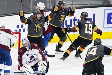 Vegas Golden Knights celebrate after center Jonathan Marchessault, top, scored against the Colorado Avalanche during the third period in Game 3 of an NHL hockey Stanley Cup second-round playoff series Friday, June 4, 2021, in Las Vegas. 