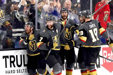 The Vegas Golden Knights celebrate a goal by Vegas Golden Knights center Jonathan Marchessault, far left, during the second period in Game 4 of an NHL hockey Stanley Cup second-round playoff series against the Colorado Avalanche at T-Mobile Arena Sunday, June 6, 2021. 