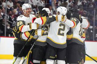 Vegas Golden Knights defenseman Nick Holden celebrates with goaltender Marc-Andre Fleury, defenseman Zach Whitecloud and right wing Reilly Smith, from left, after the Golden Knights scored in overtime of Game 5 of an NHL hockey Stanley Cup second-round playoff series against the Colorado Avalanche on Tuesday, June 8, 2021, in Denver. The Golden Knights won 3-2.