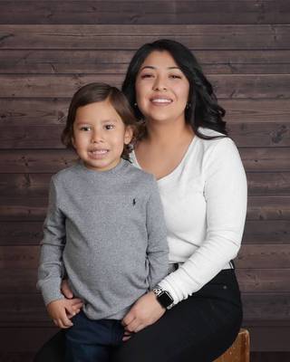 On Friday, June 4, Gov. Steve Sisolak signed an education bill that made state college tuition free for Native American tribe members using a pen stitched by Daisy Nuanes, pictured here with her son Odalis. 