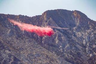 A plane drops retardant on the Sandy Valley wildfire in the Spring Mountains about two miles west of State Route 160 Friday, June 11, 2021.