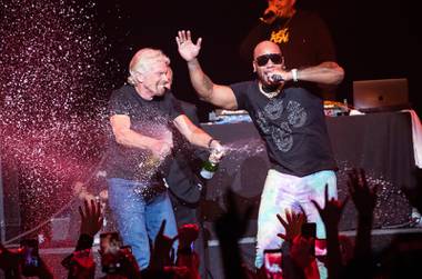 Virgin Group founder Richard Branson celebrates onstage with Flo Rida at the Theater at Virgin Hotels Las Vegas during the resort’s grand opening weekend celebration.