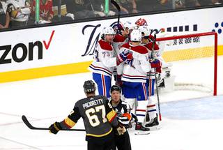 An official keeps Vegas Golden Knights left wing Max Pacioretty (67) away from celebrating Montreal Canadiens after the Golden Knights 3-2 loss in Game 2 of an NHL hockey Stanley Cup semifinal playoff series against the Montreal Canadiens at T-Mobile Arena Wednesday, June 16, 2021.
