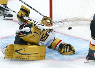Vegas Golden Knights goaltender Marc-Andre Fleury lies on the ice with the puck in the net on a goal by Montreal Canadiens' Josh Anderson during overtime in Game 3 of an NHL hockey semifinal series, Friday, June 18, 2021, in Montreal. (Paul Chiasson/The Canadian Press via AP)
