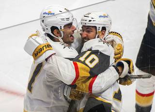 Vegas Golden Knights' Nicolas Roy (10) celebrates his game-winning goal against the Montreal Canadiens with teammate Max Pacioretty in overtime of Game 4 in an NHL Stanley Cup playoff hockey semifinal in Montreal, Sunday, June 20, 2021. (Graham Hughes/The Canadian Press via AP)