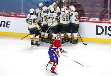 Montreal Canadiens goaltender Carey Price skates off the ice as members of the Vegas Golden Knights celebrate a goal by Nicolas Roy during overtime of Game 4 in an NHL Stanley Cup playoff hockey semifinal in Montreal, Sunday, June 20, 2021. 