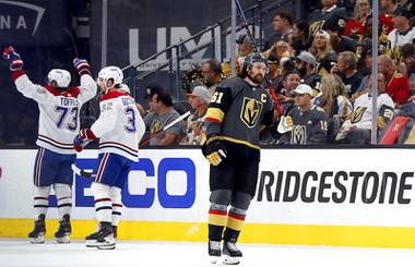 Vegas Golden Knights right wing Mark Stone (61) skates by as Montreal Canadiens right wing Tyler Toffoli (73) and defenseman Erik Gustafsson (32) celebrate a goal by Cole Caufield (not pictured) during the second period in Game 5 in an NHL Stanley Cup playoff hockey semifinal at T-Mobile Arena Tuesday, June 22, 2021.