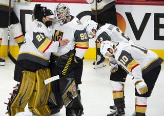 Vegas Golden Knights goaltenders Marc-Andre Fleury (29) and Robin Lehner (90) console each other after losing to the Montreal Canadiens in Game 6 of an NHL hockey Stanley Cup semifinal playoff series Thursday, June 24, 2021 in Montreal. (Ryan Remiorz/The Canadian Press via AP)
