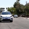 An electric Kia Niro travels down a residential street in Las Vegas during a demonstration of the Halo driverless vehicle service, Thursday, July 8, 2021. 