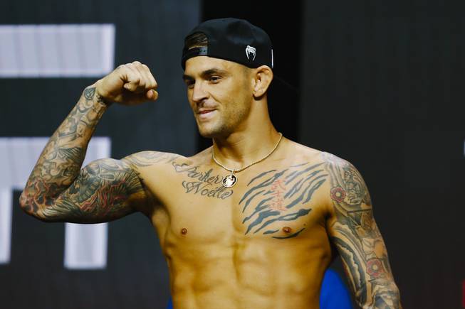 Dustin Poirier flexes for fans during the UFC 264 ceremonial weigh-in at T-Mobile Arena Friday, July 9, 2021.