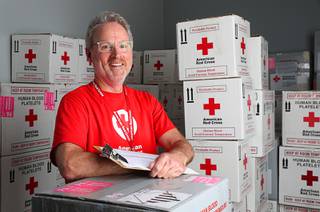 American Red Cross volunteer driver Jerry Runyon poses in the Red Cross offices after a delivery Wednesday, July 21, 2021.