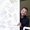Flavio Jimenez, vice president for development of the Hispanic market for Fathom Realty, poses by a message door at his office Wednesday, July 21, 2021. The door is covered with messages from satisfied customers.