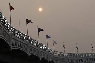 Smoke from Western wildfires dims the sun before the Philadelphia Phillies played New York Yankees in a baseball game Tuesday, July 20, 2021, in New York. (AP Photo/Adam Hunger)